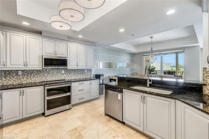 Kitchen with stainless appliances, new range and microwave.