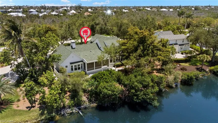Aerial view of property's location with a nearby body of water