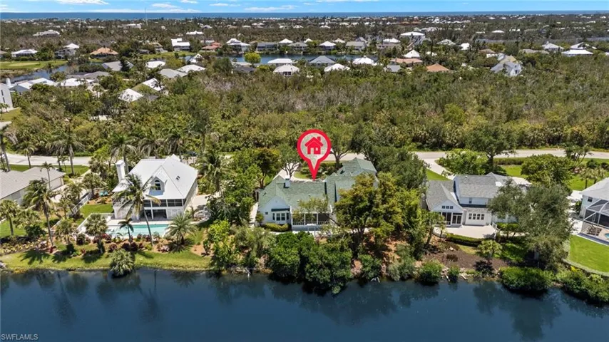 Aerial perspective of suburban area featuring a large body of water