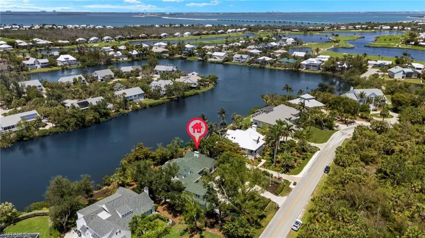 Aerial overview of property's location featuring nearby suburban area and a large body of water