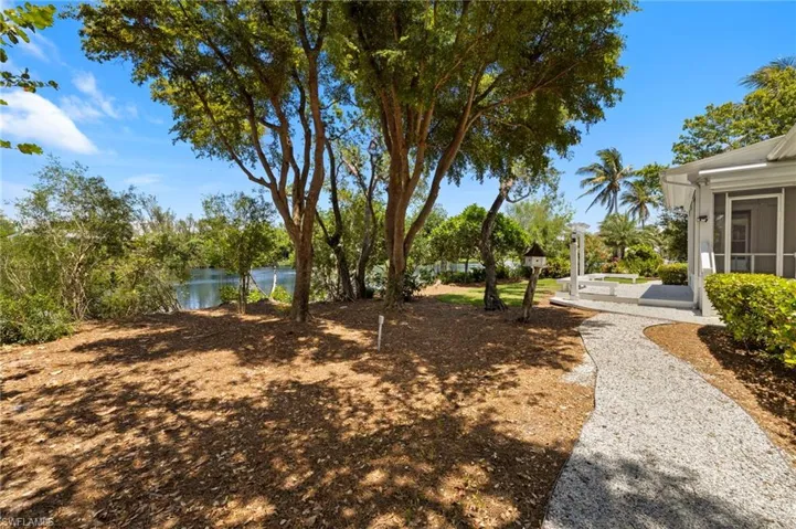 View of yard with a lake view and a sunroom