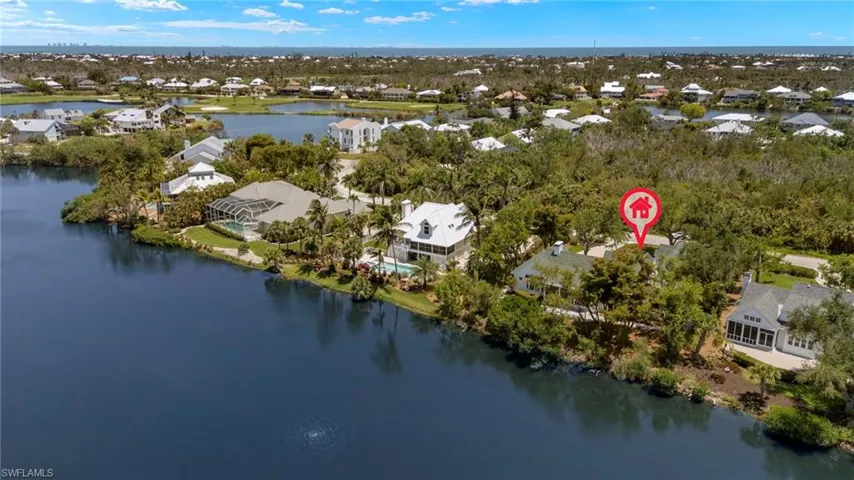 Aerial view of property and surrounding area featuring nearby suburban area