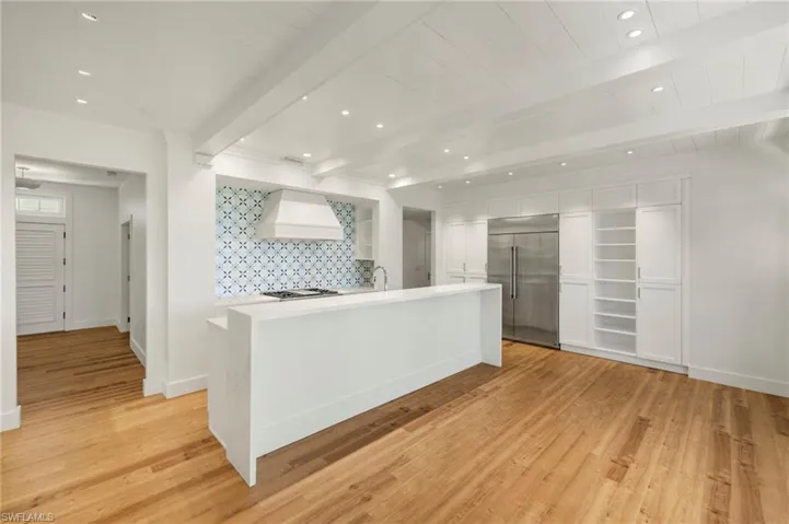 Kitchen featuring recessed lighting, appliances with stainless steel finishes, beam ceiling, white cabinetry, and decorative backsplash