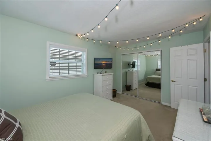Carpeted bedroom featuring a closet