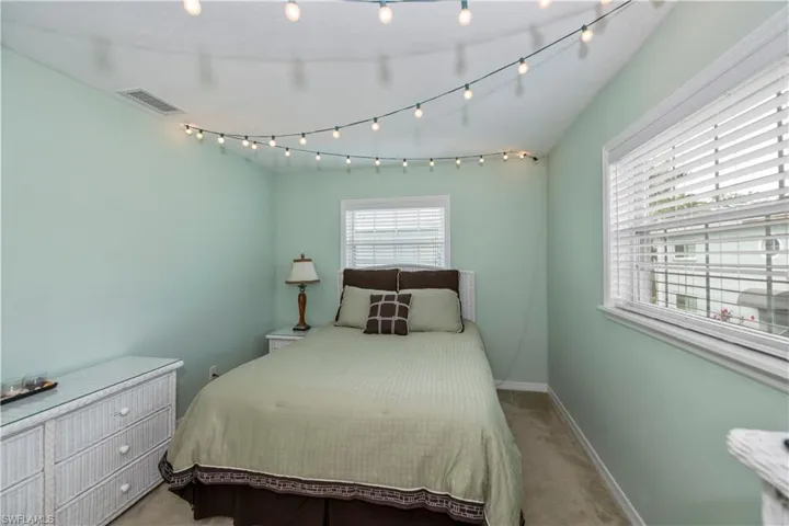 Bedroom featuring light carpet