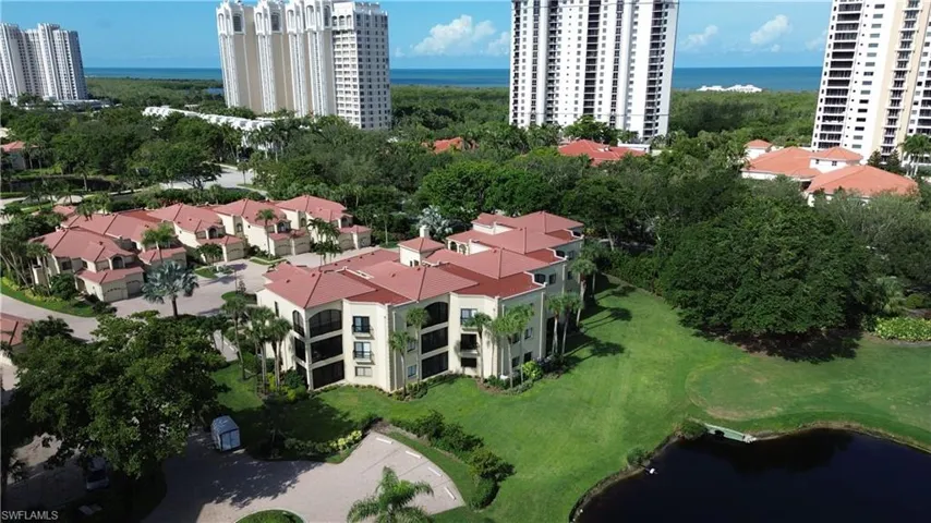Aerial view of a large body of water and apartment complex / building