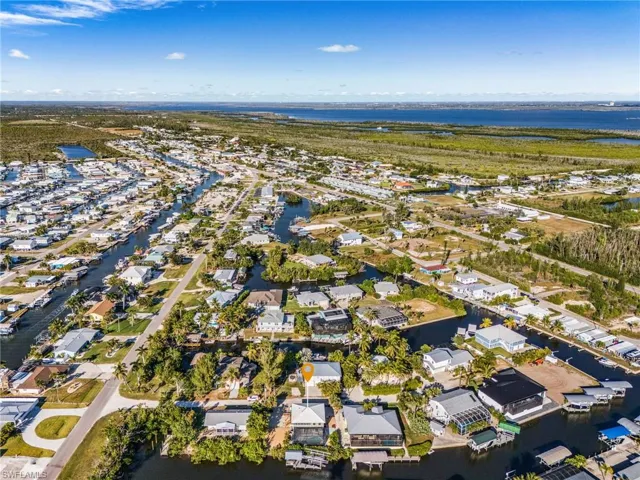 View of property location with a nearby body of water and nearby suburban area