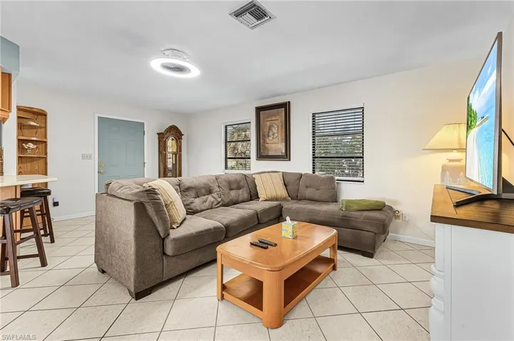 Living room featuring light tile floors and baseboards