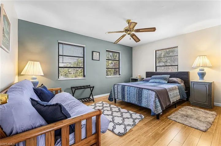 Bedroom with ceiling fan and wood finished floors