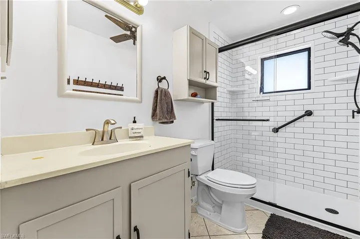 Bathroom featuring vanity, a stall shower, and light tile patterned floors