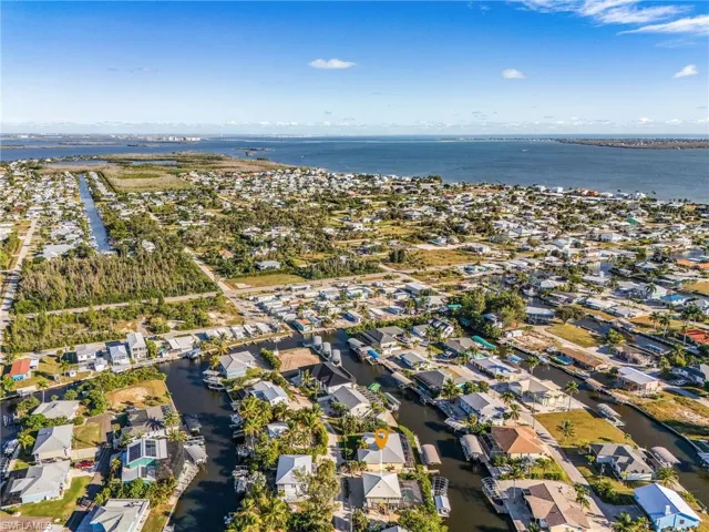 Aerial overview of property's location featuring a large body of water and nearby suburban area