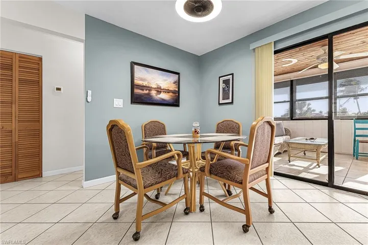 Dining room with light tile floors and a ceiling fan