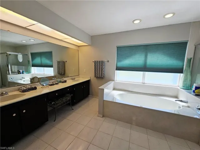 Master bath with dual sink vanity and soaking tub
