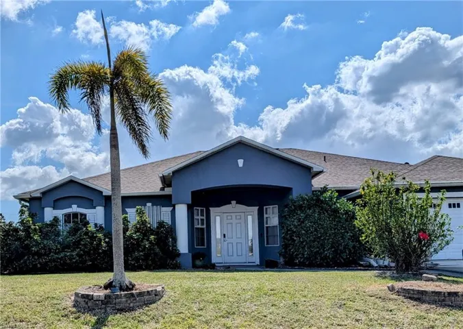 Ranch-style house with a garage and a front yard.