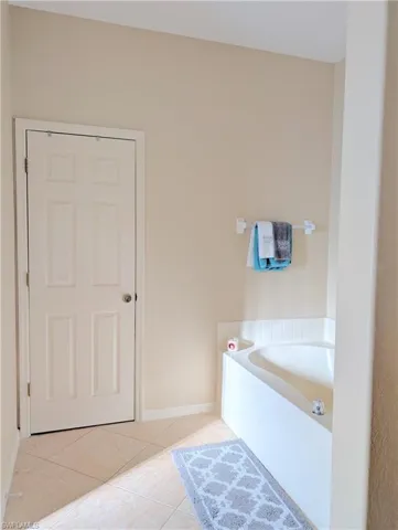 Bathroom featuring tile flooring and walk in closet