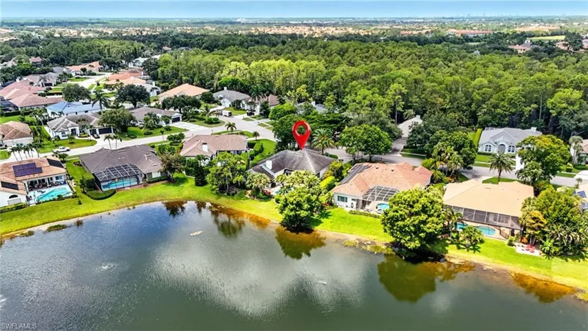 Aerial perspective of suburban area featuring a nearby body of water