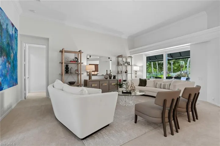 Living area featuring crown molding and carpet flooring
