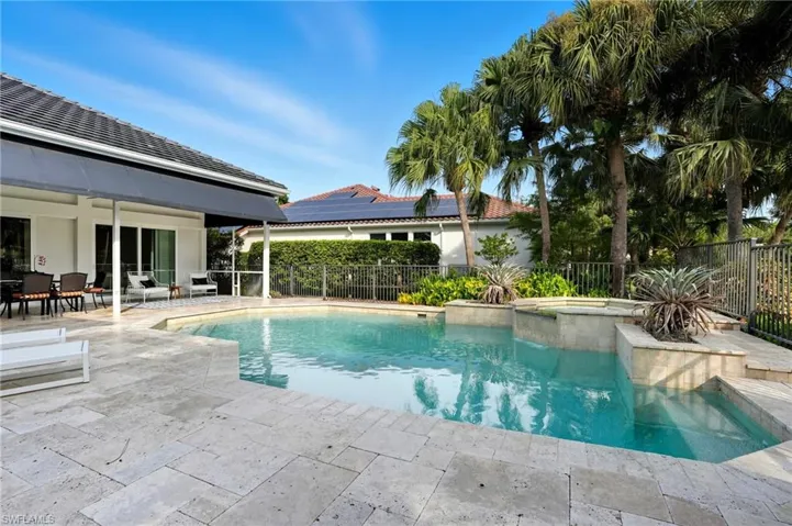 View of swimming pool with a patio area, a fenced backyard, and a pool with connected hot tub