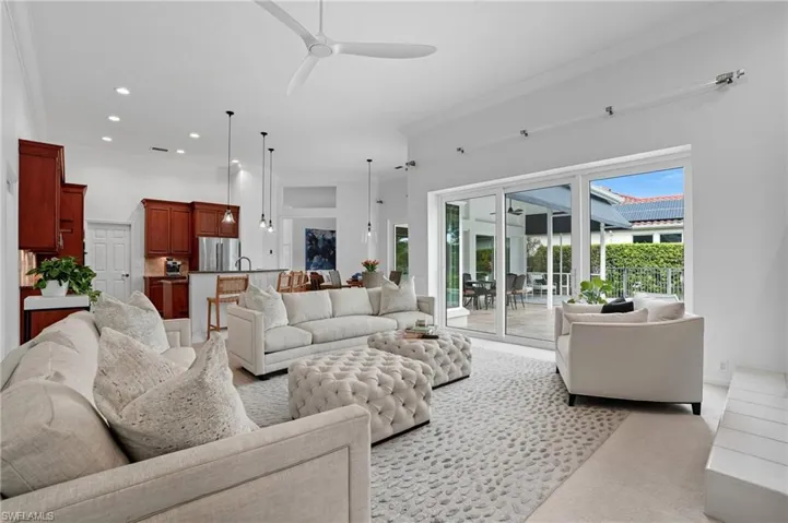 Living room with ceiling fan, crown molding, recessed lighting, and light colored carpet