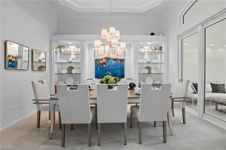 Dining area featuring a chandelier and light carpet