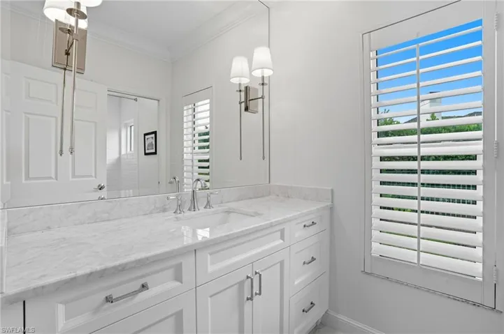 Bathroom with vanity and ornamental molding
