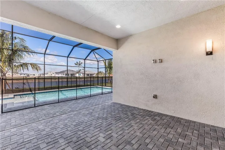 Large covered lanai with pool and protective fencing.