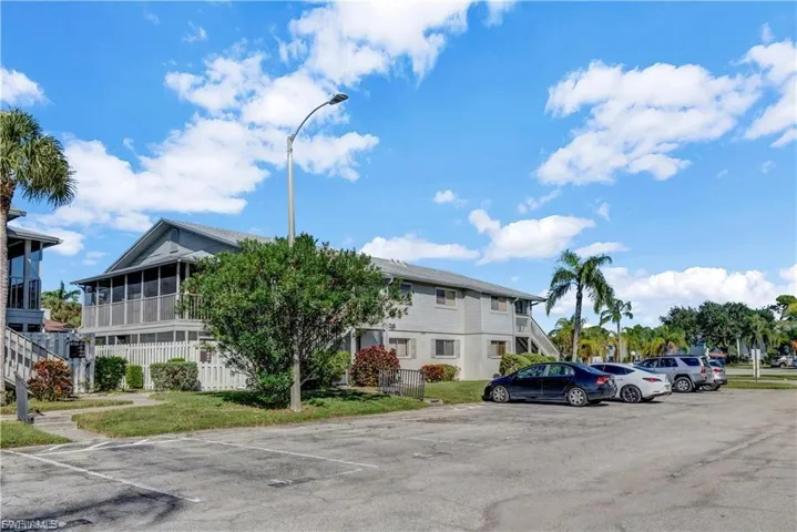 View of building exterior featuring uncovered parking