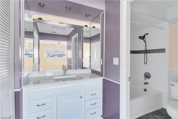 Full bath featuring vanity, bathtub / shower combination, and a closet
