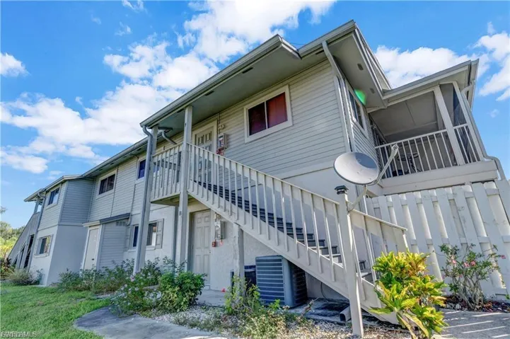 View of property featuring stairs