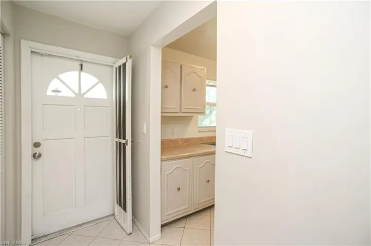 Entryway with light tile patterned floors