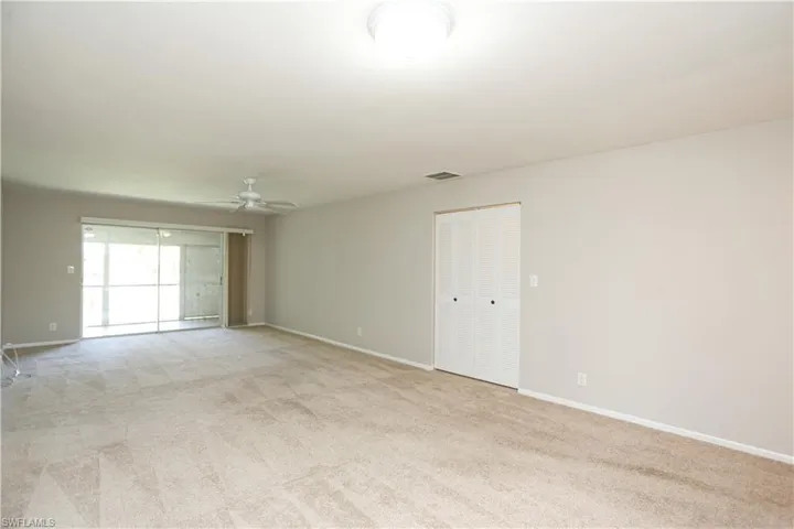 Unfurnished room with ceiling fan and light colored carpet