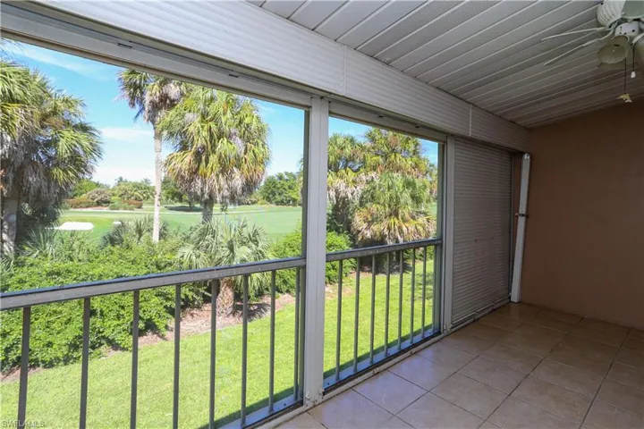 Unfurnished sunroom with ceiling fan