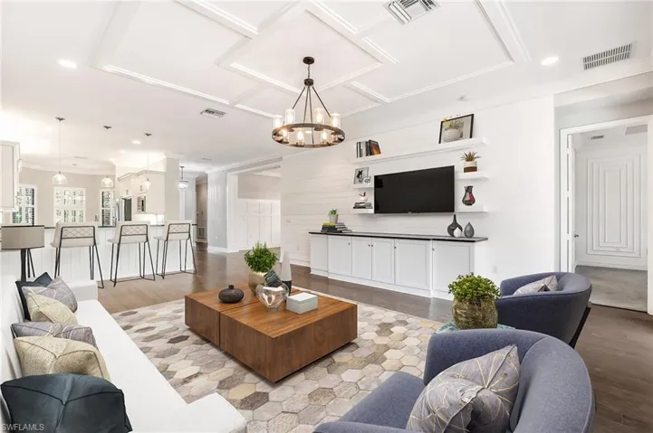 Spacious, open great room with custom built-in and accents (virtually staged)