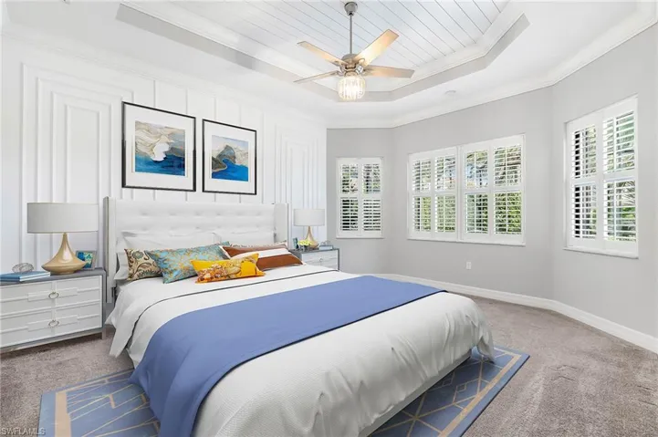 Spacious master ensuite, with sitting area, recessed ceiling and elegant wood trim finishes (virtually staged)