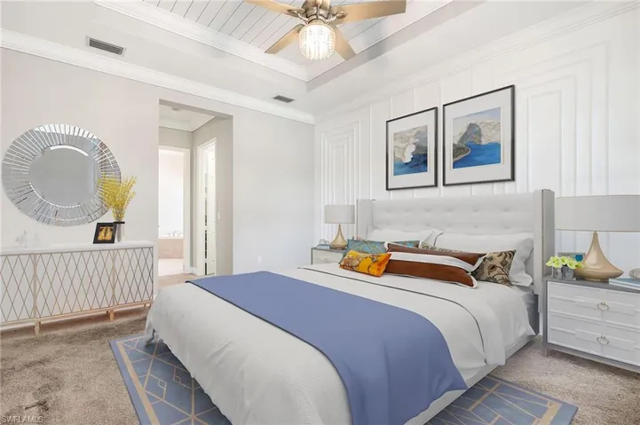 Spacious master ensuite, with sitting area, recessed ceiling and elegant wood trim finishes (virtually staged)