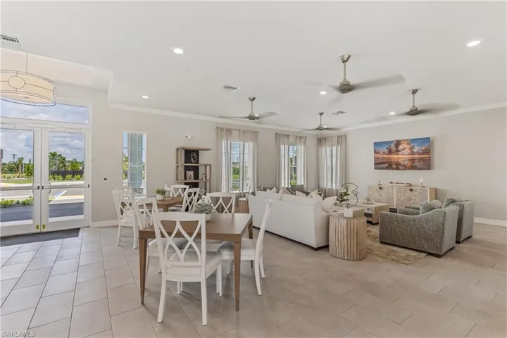 Recessed lighting, crown molding, and ceiling fans complement the open-concept design