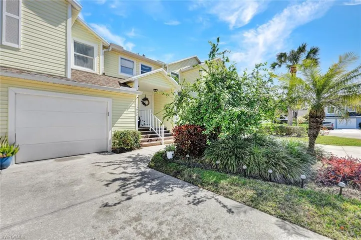 View of front of home featuring concrete driveway and an attached garage