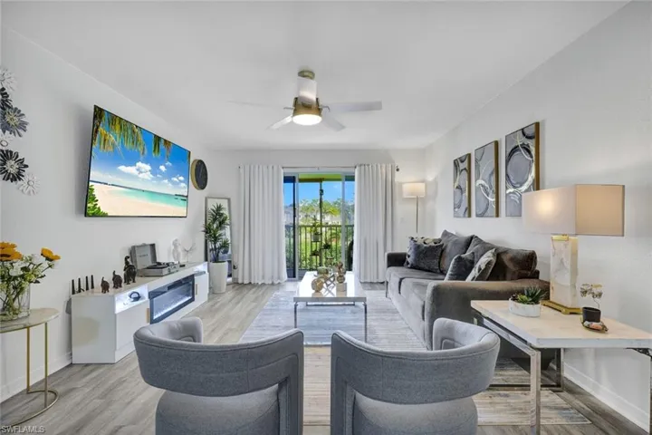 Living area with light wood finished floors and ceiling fan
