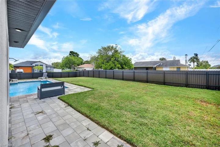 Yard with brick pavers around the whole house and fenced back yard