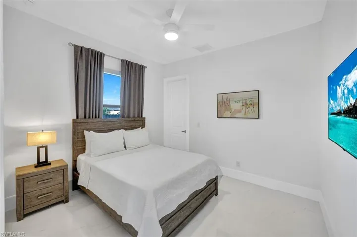 Bedroom with a ceiling fan and baseboards