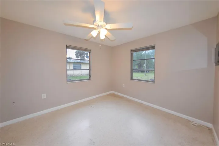 Unfurnished room featuring ceiling fan and a healthy amount of sunlight