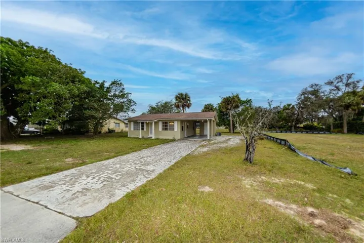 Single story home with a front lawn