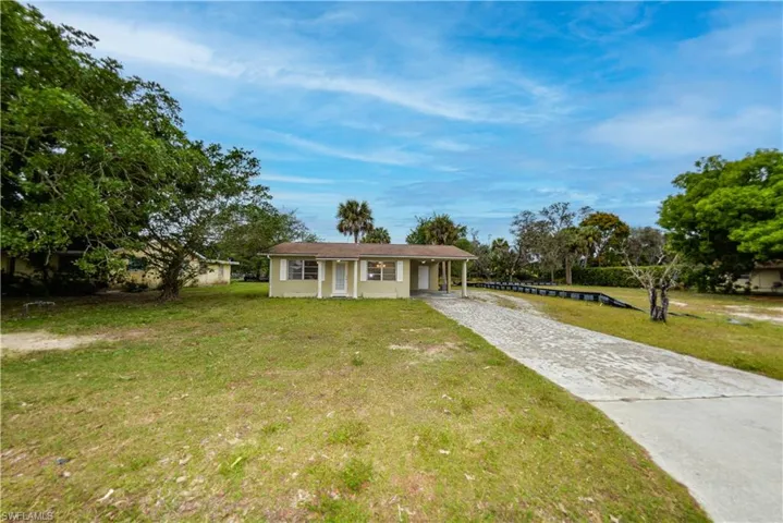 Ranch-style home featuring a front yard