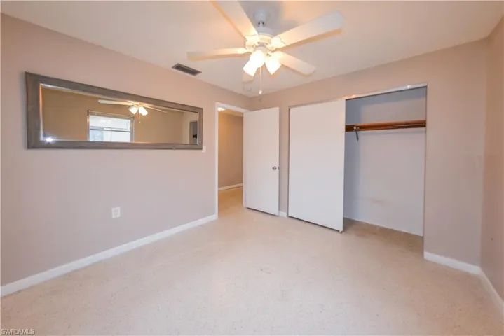 Unfurnished bedroom with a closet and ceiling fan