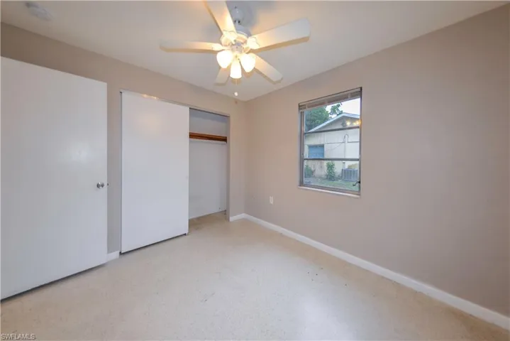 Unfurnished bedroom with a closet and ceiling fan