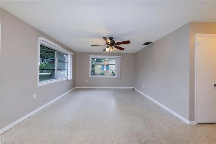 Empty room with a healthy amount of sunlight and ceiling fan