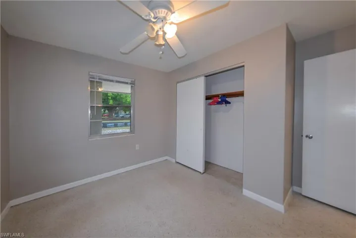 Unfurnished bedroom featuring ceiling fan and a closet