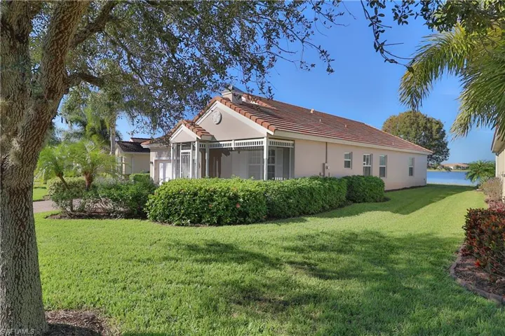 Rear view of house featuring a yard