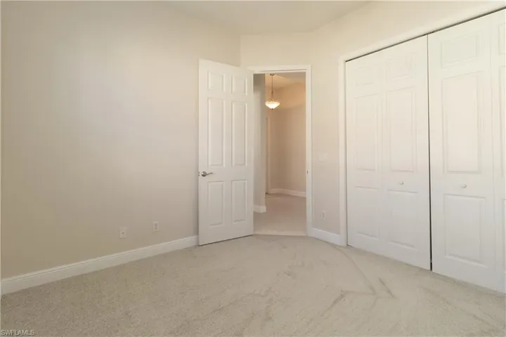 Unfurnished bedroom with a closet and carpet