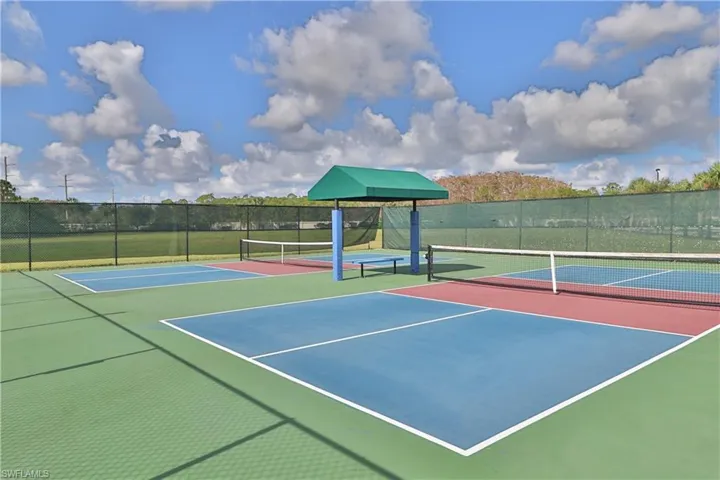 View of tennis court featuring basketball court